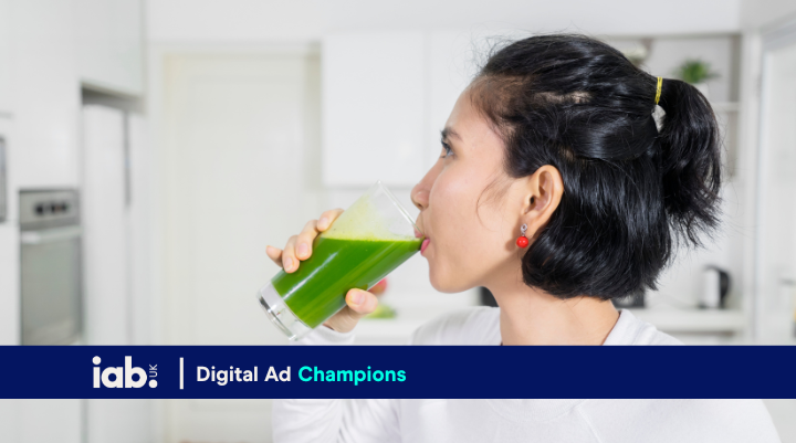 a woman drinking a green juice 